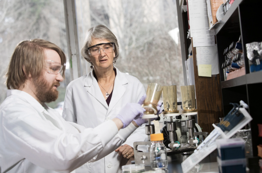 Professor Diana Downs interacts with graduate student Andrew Borchert inside a biology laboratory.