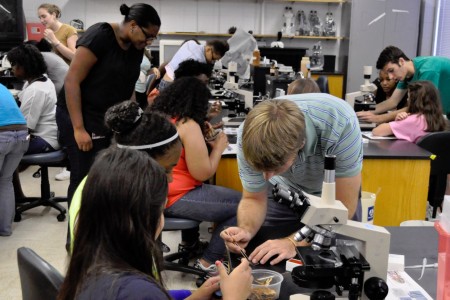 UGA Microbiology graduate students working with members of Girls Inc in the lab